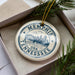 A circular ornament with the text "MEMPHIS TENNESSEE USA" printed on it, surrounded by pine branches.