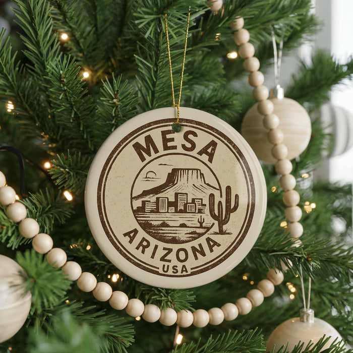 A Christmas tree decorated with ornaments, including a circular ornament with the text "Mesa, Arizona, USA" and a cactus design.