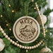 A Christmas tree decorated with ornaments, including a circular ornament with the text "Mesa, Arizona, USA" and a cactus design.