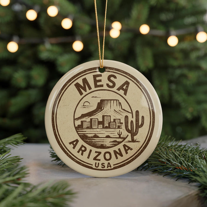 A circular ornament with the text "Mesa Arizona USA" printed on it, featuring a mountain and desert landscape.