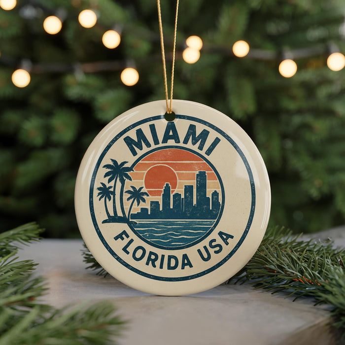 A circular ornament with the text "MIAMI FLORIDA USA" and a graphic of a city skyline with palm trees, hanging from a string.