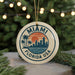A circular ornament with the text "MIAMI FLORIDA USA" and a graphic of a city skyline with palm trees, hanging from a string.