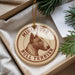 A round ornament with a bull terrier image and the text "MINIATURE BULL TERRIER" is displayed in a box with pine branches.