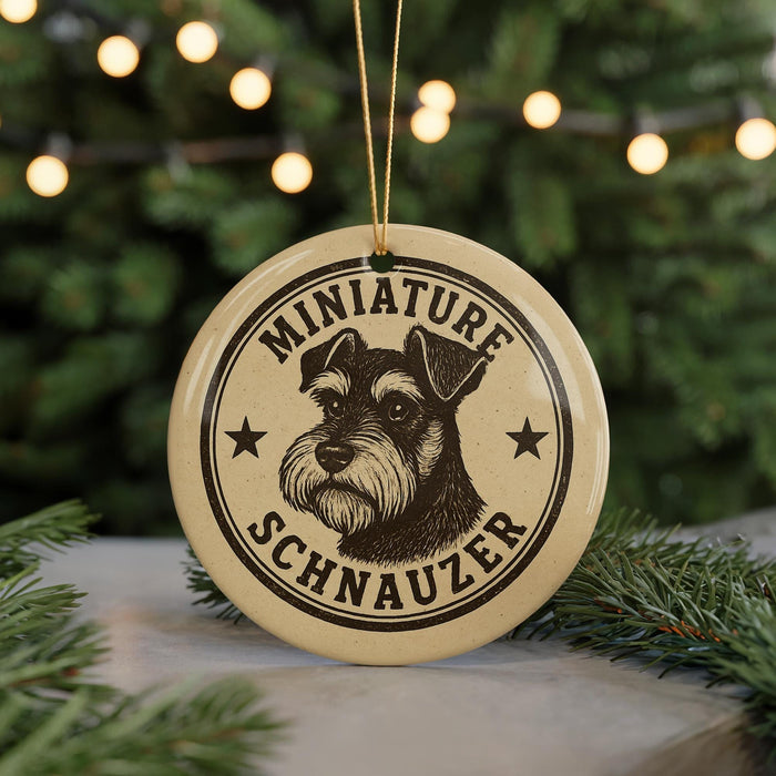 A round ornament featuring a black and white illustration of a miniature schnauzer dog, with the text "MINIATURE SCHNAUZER" printed on it.