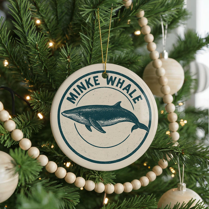 A Christmas tree decorated with ornaments, including a circular ornament with a blue whale image and the text "MINKE WHALE" around the edge.