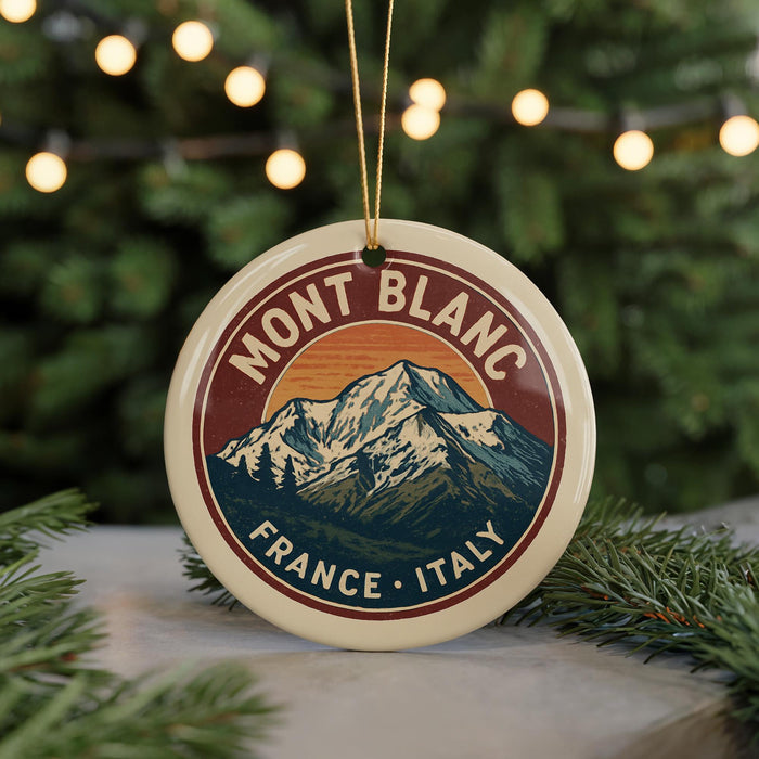 A round ornament with a mountain and trees design, featuring the text "MONT BLANC FRANCE ITALY" on it.
