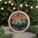 A round ornament with a mountain and trees design, featuring the text "MONT BLANC FRANCE ITALY" on it.