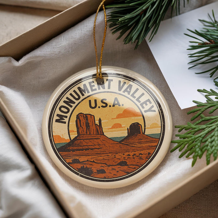 A decorative ornament featuring a scenic illustration of Monument Valley, a famous landmark in the United States.
