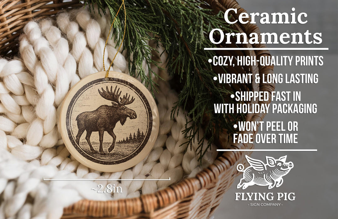 Ceramic ornaments, featuring a moose and pine tree design, are displayed in a woven basket.