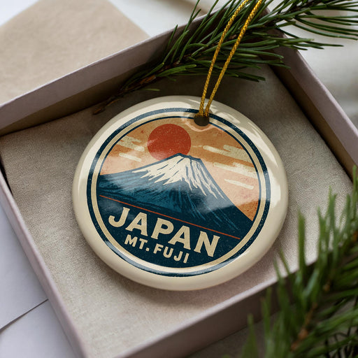 A circular ornament with a mountain and sun design, featuring the text "JAPAN Mt. fuji".