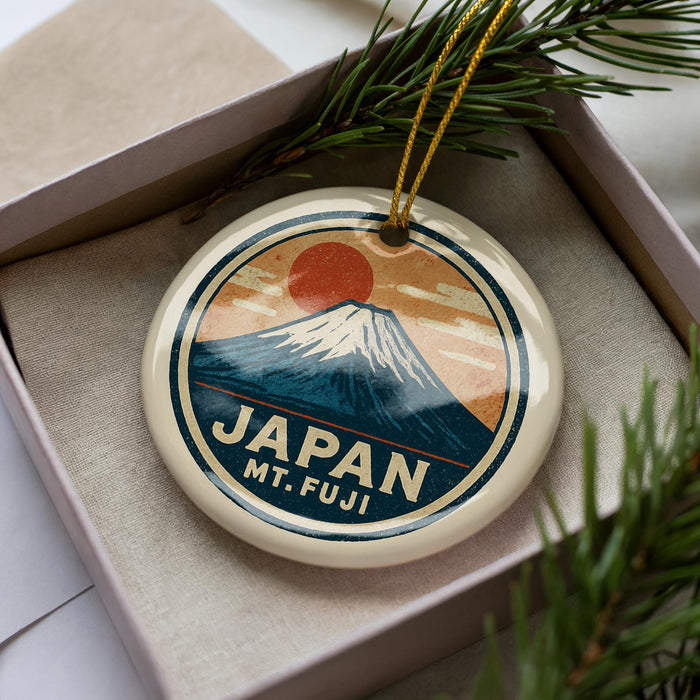 A circular ornament with a mountain and sun design, featuring the text "JAPAN Mt. fuji".