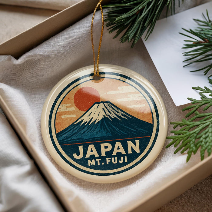 A circular ornament with a mountain and sun design, featuring the text "JAPAN Mt. fuji".