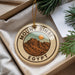 A decorative ornament with the text "Mount Sinai Egypt" and an illustration of a mountain range, hanging from a string.