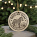 A round ornament featuring a zebra standing in a grassy field, with the text "MOUNTAIN ZEBRA" around the edge.
