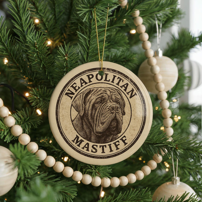A Christmas tree decorated with ornaments, including a circular ornament with the text "NEAPOLITAN MASTIFF" and a picture of a dog.