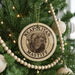 A Christmas tree decorated with ornaments, including a circular ornament with the text "NEAPOLITAN MASTIFF" and a picture of a dog.