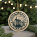 A circular ornament with the text "NEUSCHWANSTEIN CASTLE GERMANY" and an illustration of a castle, hanging from a string.