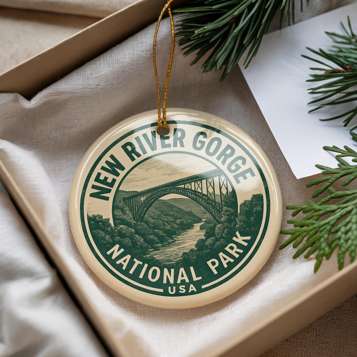 A decorative ornament with the text "NEW RIVER GORGE NATIONAL PARK USA" printed on it, hanging from a string.