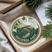 A decorative ornament with the text "NEW RIVER GORGE NATIONAL PARK USA" printed on it, hanging from a string.