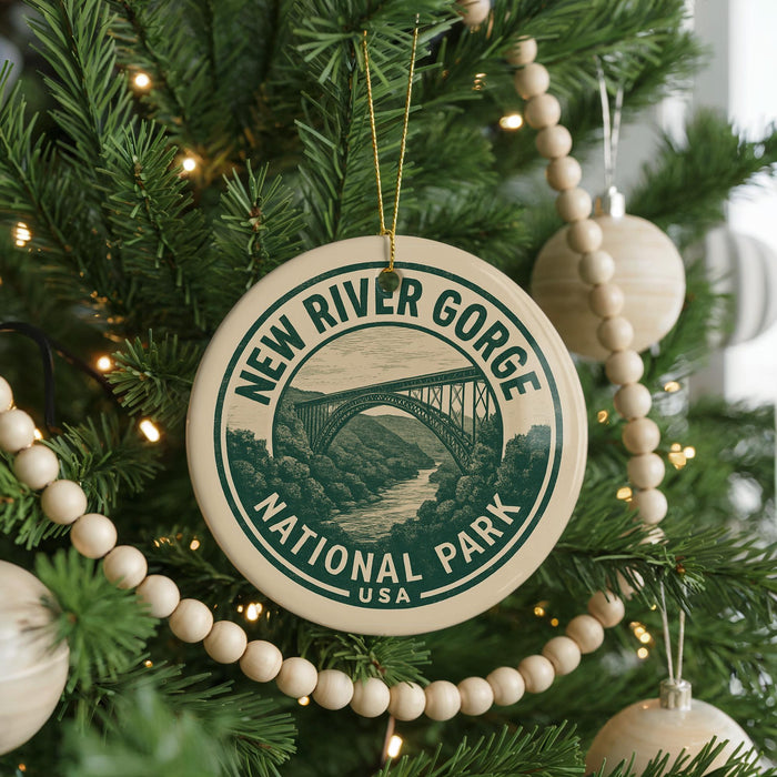 A Christmas tree decorated with ornaments, including a circular ornament with the text "NEW RIVER GORGE NATIONAL PARK USA" and a bridge illustration.
