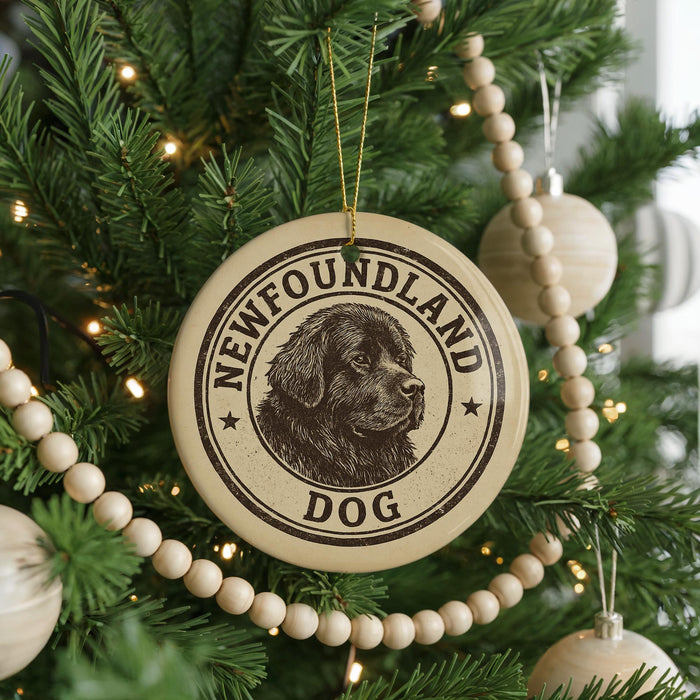 A Christmas tree decorated with ornaments, including a circular ornament with the text "Newfoundland Dog" and a dog image.