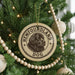 A Christmas tree decorated with ornaments, including a circular ornament with the text "Newfoundland Dog" and a dog image.