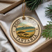 A decorative ornament with the text "NGORONGOORO TANZANIA" and a landscape image of the African continent, surrounded by greenery.