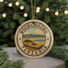 A circular ornament with the text "NGORONGORO TANZANIA" and an illustration of a landscape with mountains and trees.