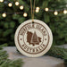 A white ornament with the text "NORFOLK ISLAND AUSTRALIA" printed on it, featuring a tree silhouette and a map of Norfolk Island.