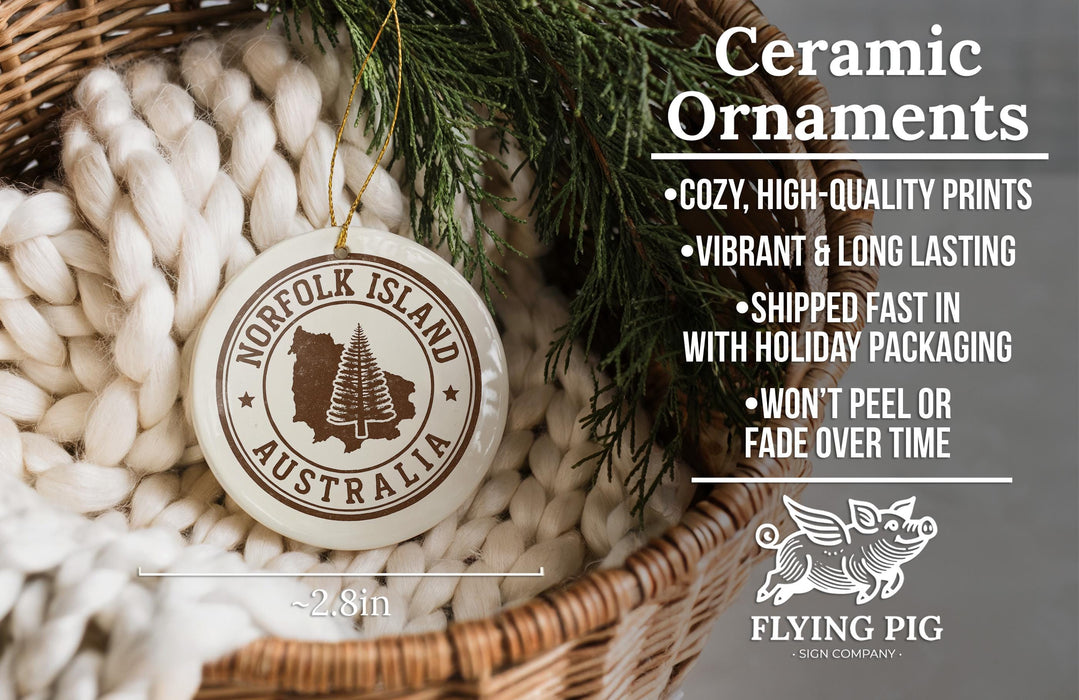 Ceramic ornaments, including a round ornament with the text "NORFOLK ISLAND AUSTRALIA" and a wicker basket with greenery.