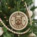 A Christmas tree decorated with ornaments, including a circular ornament with a terrier dog image and the text "NORWICH TERRIER".
