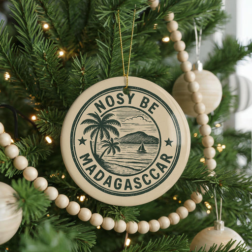 A Christmas tree decorated with ornaments, including a circular ornament with the text "NOSY BE MADAGASCAR" and a palm tree design.