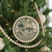 A Christmas tree decorated with ornaments, including a circular ornament with the text "NOSY BE MADAGASCAR" and a palm tree design.