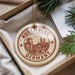 A circular ornament with the text "NUREMBERG GERMANY" printed on it, hanging from a string.