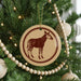 A Christmas tree decorated with ornaments, including a circular ornament featuring a zebra silhouette.