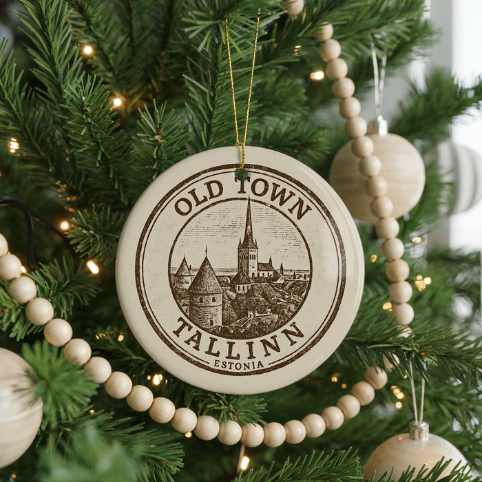 A Christmas tree decorated with ornaments, including a circular ornament with the text "OLD TOWN TALLINN ESTONIA" and a castle illustration.