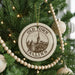 A Christmas tree decorated with ornaments, including a circular ornament with the text "OLD TOWN TALLINN ESTONIA" and a castle illustration.
