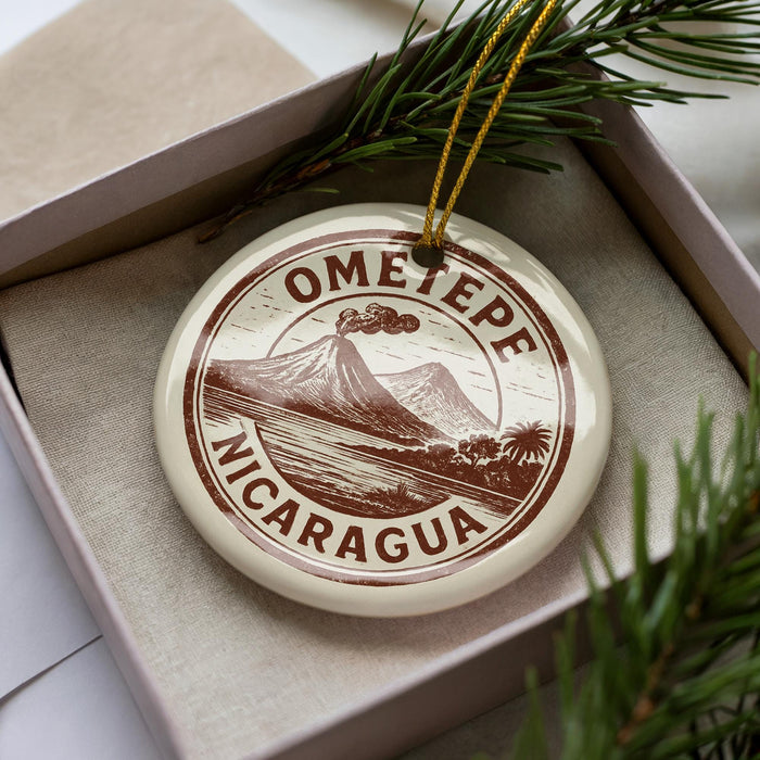 A circular ornament with the text "OMETEpe Nicaragua" printed on it, surrounded by pine branches.