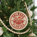 A Christmas tree decorated with ornaments, including a circular ornament with the text "ORLANDO FLORIDA" and a palm tree design.