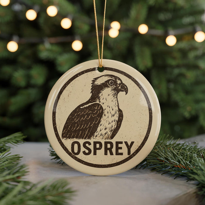 A circular ornament featuring an illustration of an Osprey bird, with the word "OSPREY" written below it.