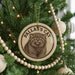 A Christmas tree decorated with ornaments, including a circular ornament with a cat image and the text "PALLAS'S CAT".