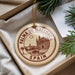 A circular ornament with the text "PALMA DE MALLORCA" and "SPAIN" printed on it, hanging from a string.