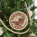 A Christmas tree decorated with ornaments, including a circular ornament with the text "PALMA DE MALLORCA SPAIN" and a castle illustration.