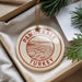 A circular ornament with the text "PAMUKKALE TURKEY" printed on it, hanging from a string.