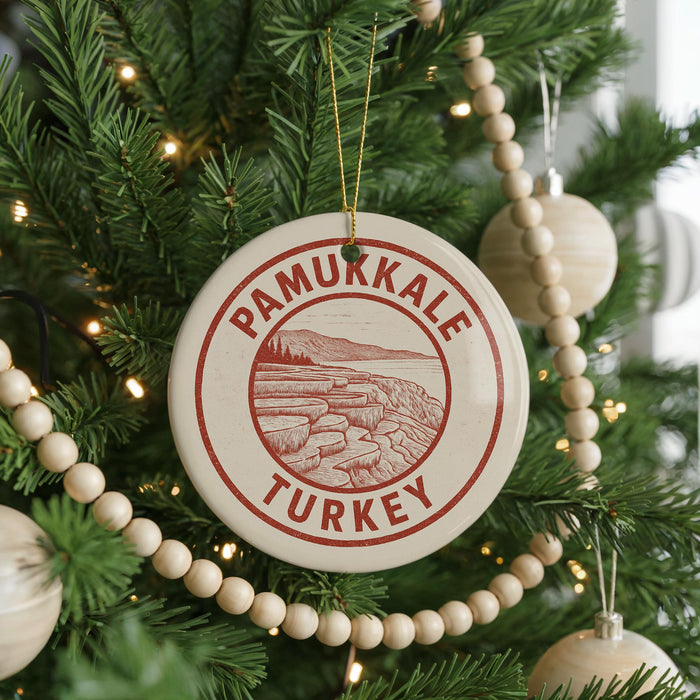 A Christmas tree decorated with ornaments, including a circular ornament with the text "PAMUKKALE TURKEY" and a beaded ornament.