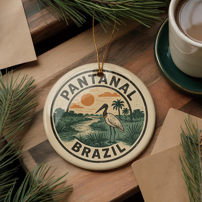 A circular ornament with the text "PANTANAL BRASIL" and an illustration of a bird standing on a tropical island, surrounded by palm trees and a sunset.