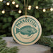 A round ornament with the word "PARROTFISH" and a fish illustration, hanging from a string.