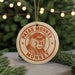 A circular ornament with the text "PATAS MONKEY" and an illustration of a monkey's face is hanging from a string.