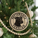 A Christmas tree decorated with ornaments, including a circular ornament with a black and white illustration of a terrier dog and the text "PATTERDALE TERRIER".
