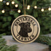 A circular ornament featuring a black and white illustration of a terrier dog, with the text "PATTERDALE TERRIER" printed on it.